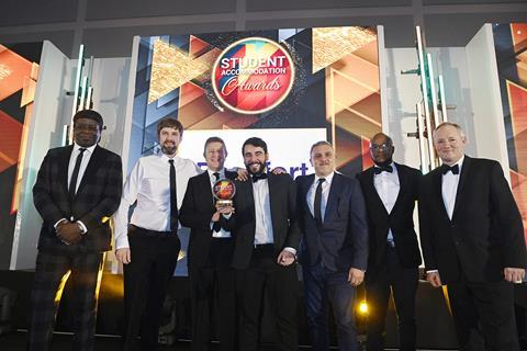 Mark Quigley, of Beaufort, gives a delighted UAL team their Halls of Residence prize